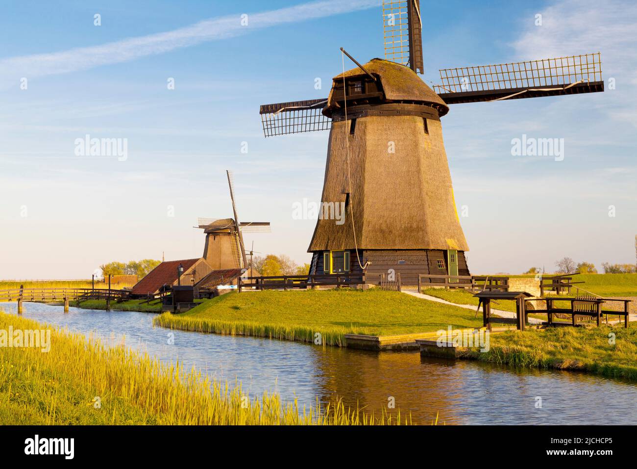 Traditional windmills beside a canal, Schermerhorn, North Holland, Netherlands Stock Photo