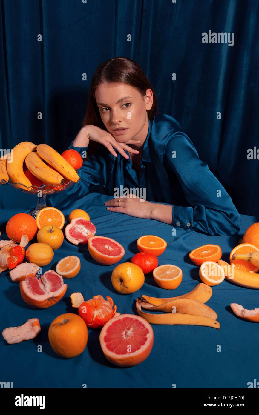 Woman with fruit, over a blue background Stock Photo