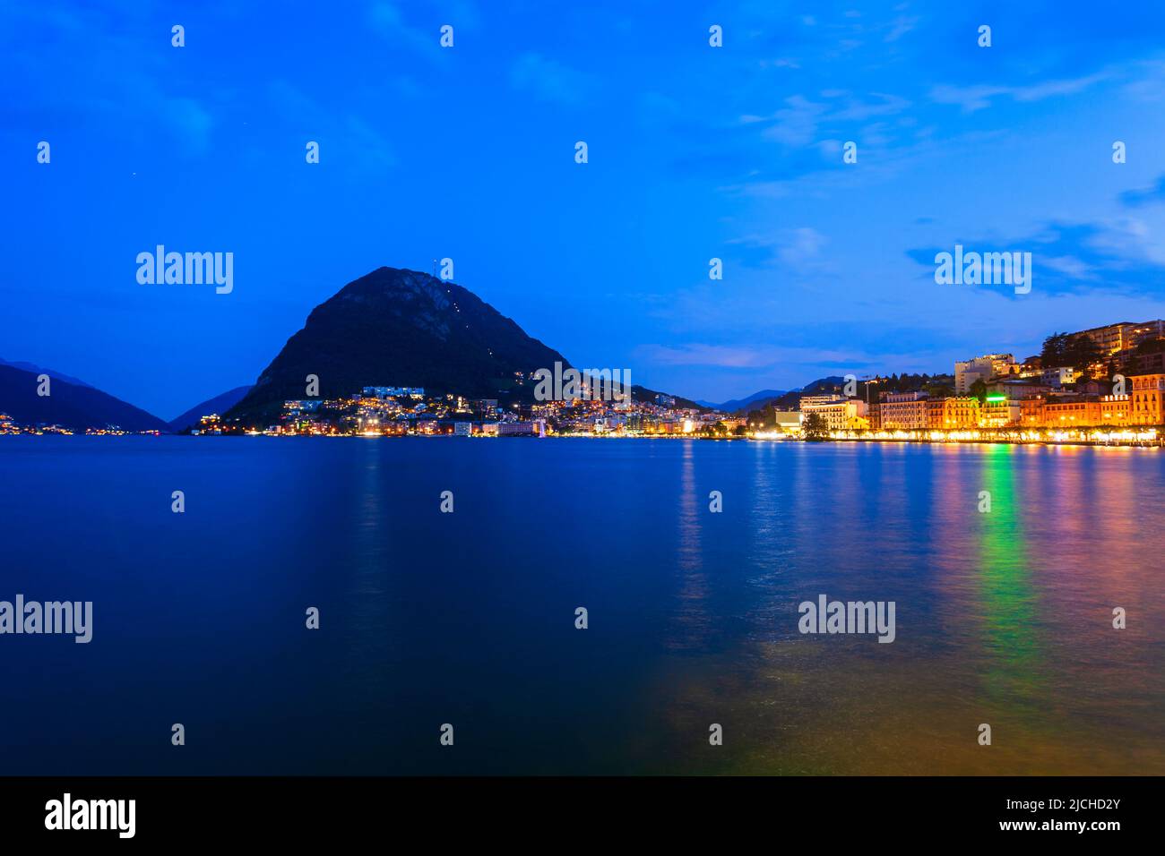 Lugano lake and Lugano city panoramic view in canton of Ticino in Switzerland at night Stock Photo