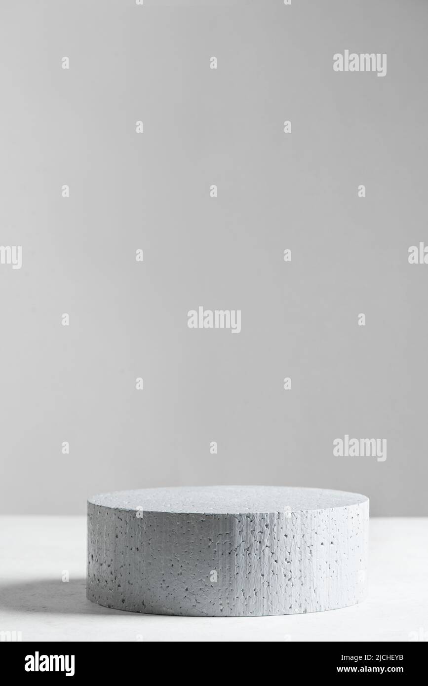 Empty stone podium on gray backdrop, scene with copy space for your products presentation. Empty modern minimal concept mock up for cosmetic, skin car Stock Photo