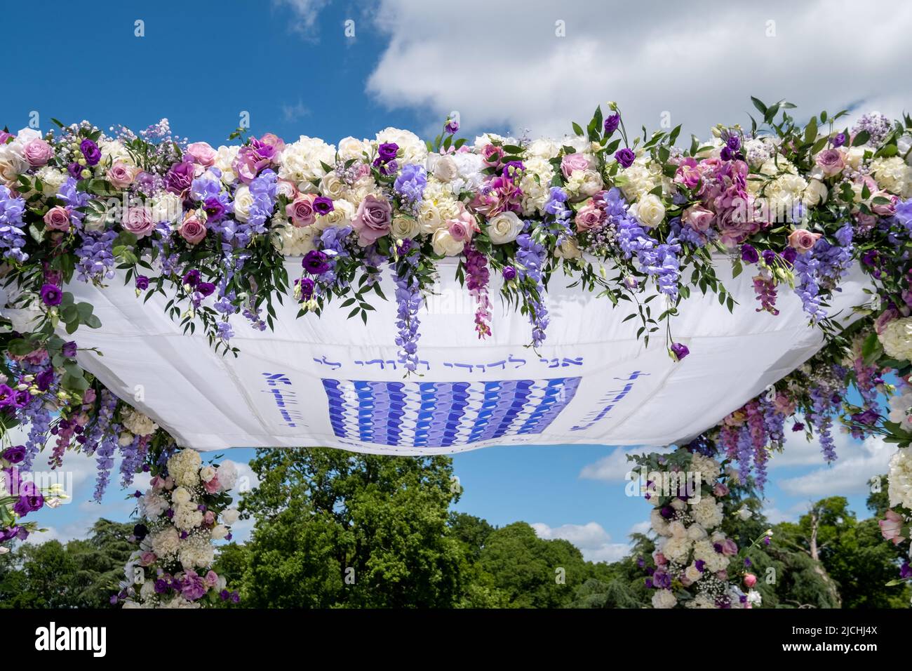 Jewish couple at marriage ceremony under chuppa wedding canopy. Canopy