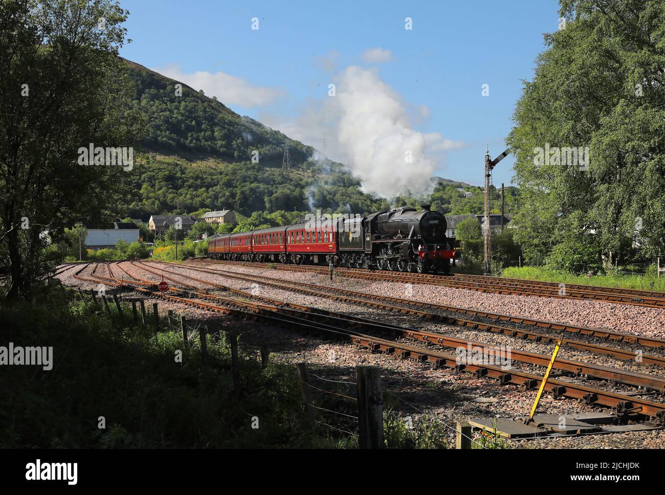 45407 gets away from Fort William with the morning 'Jacobite' service to Mallaig on 1.6.22. Stock Photo