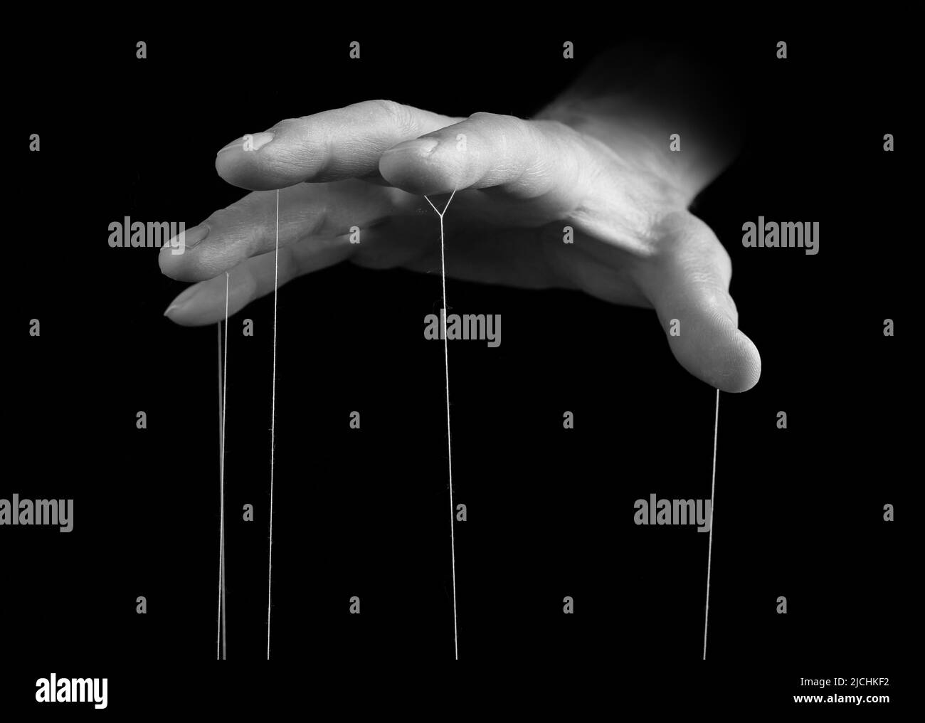Man hand with strings on fingers. Suffering from drug, gambling, internet addiction or manipulation, influence concept. Black and white. High quality photo Stock Photo