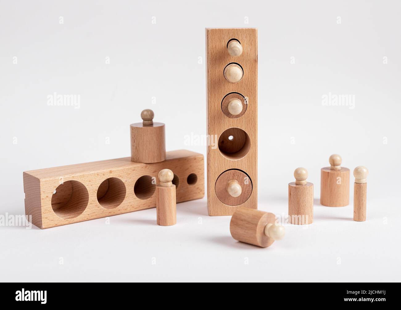 Montessori knobbed wooden cylinders with blocks. Puzzle for teaching child to distinguish small differences in size. High quality photo Stock Photo
