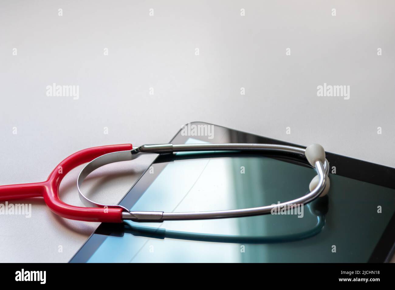 Red stethoscope on black tablet device shows health records and digital patient records on cloud data security for digital doctors and digital recover Stock Photo