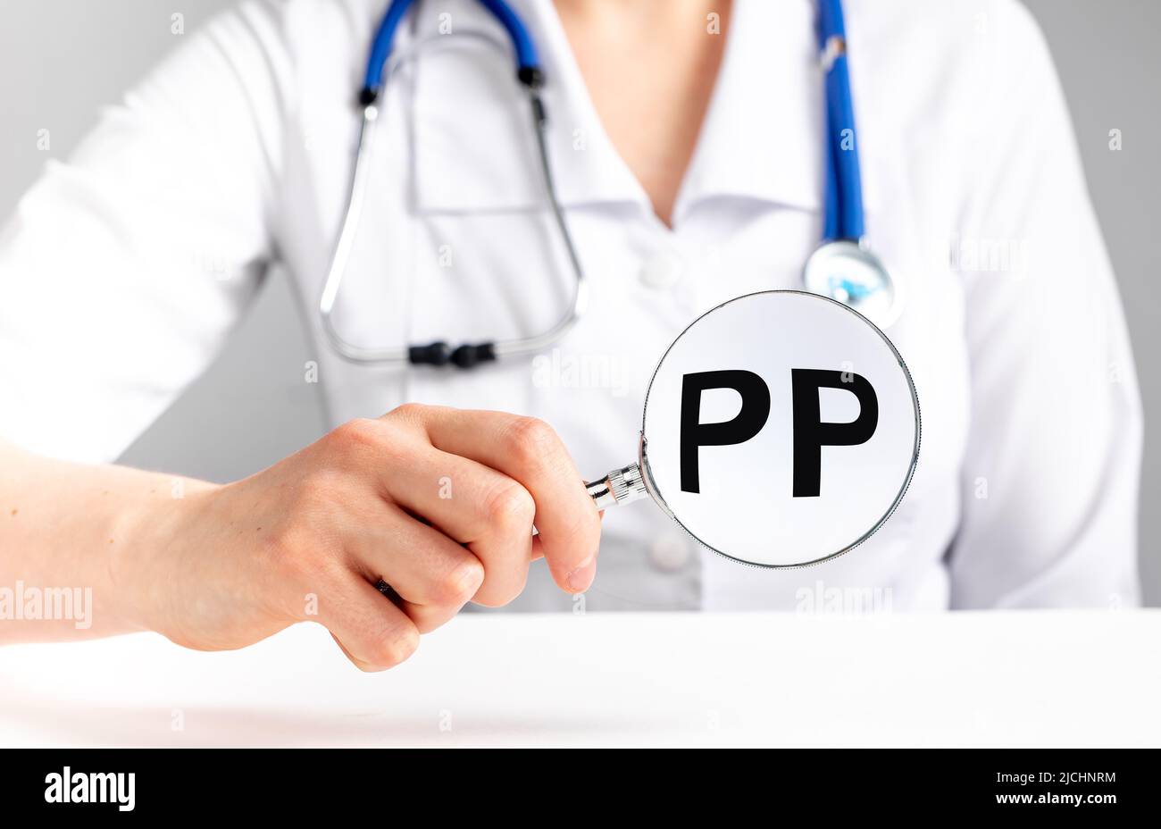 PP vitamin, word acronym through magnifying glass. High quality photo Stock Photo