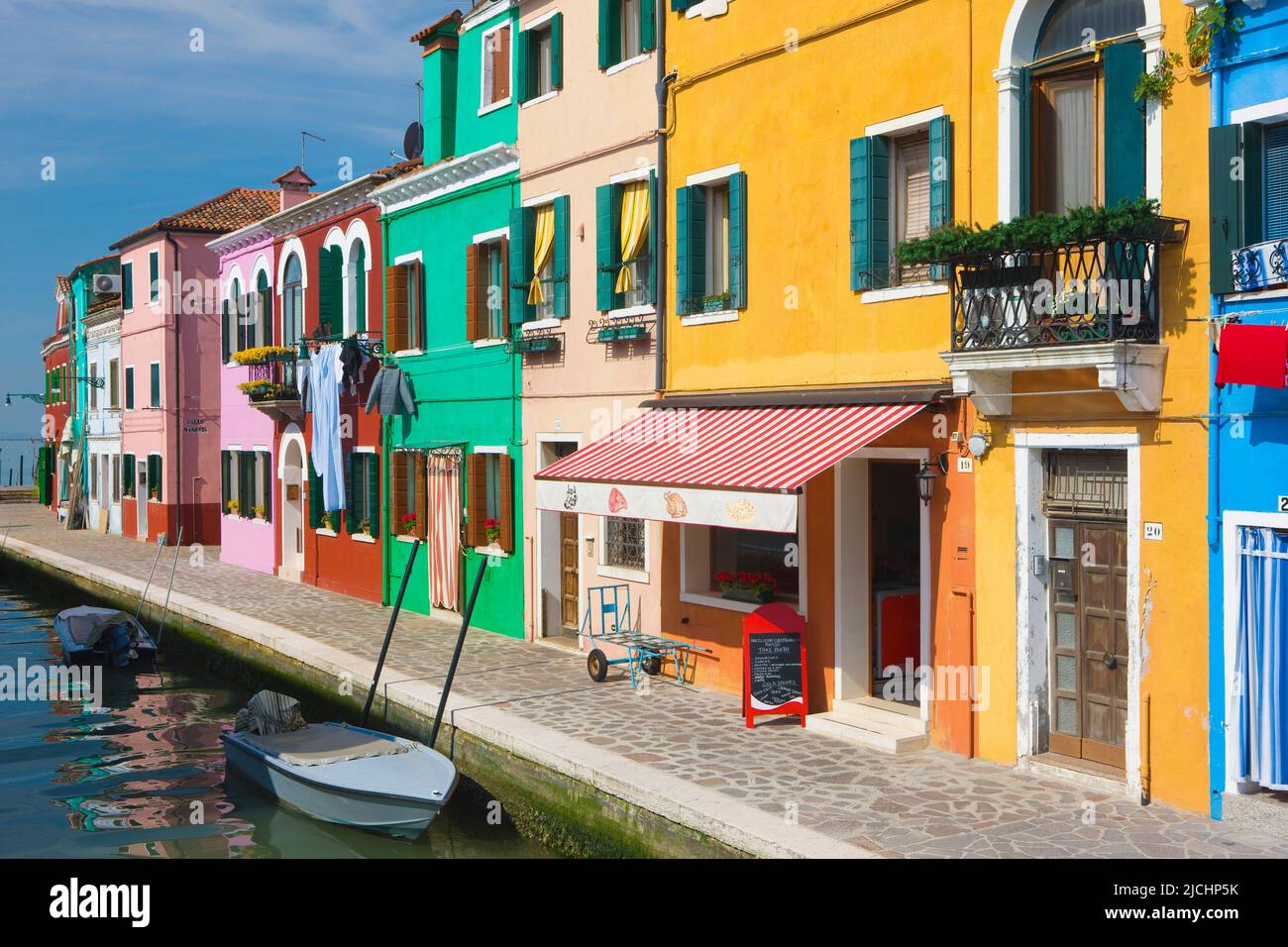 Colourful buildings lining a canal, island of Burano, Venice, Veneto, Italy Stock Photo