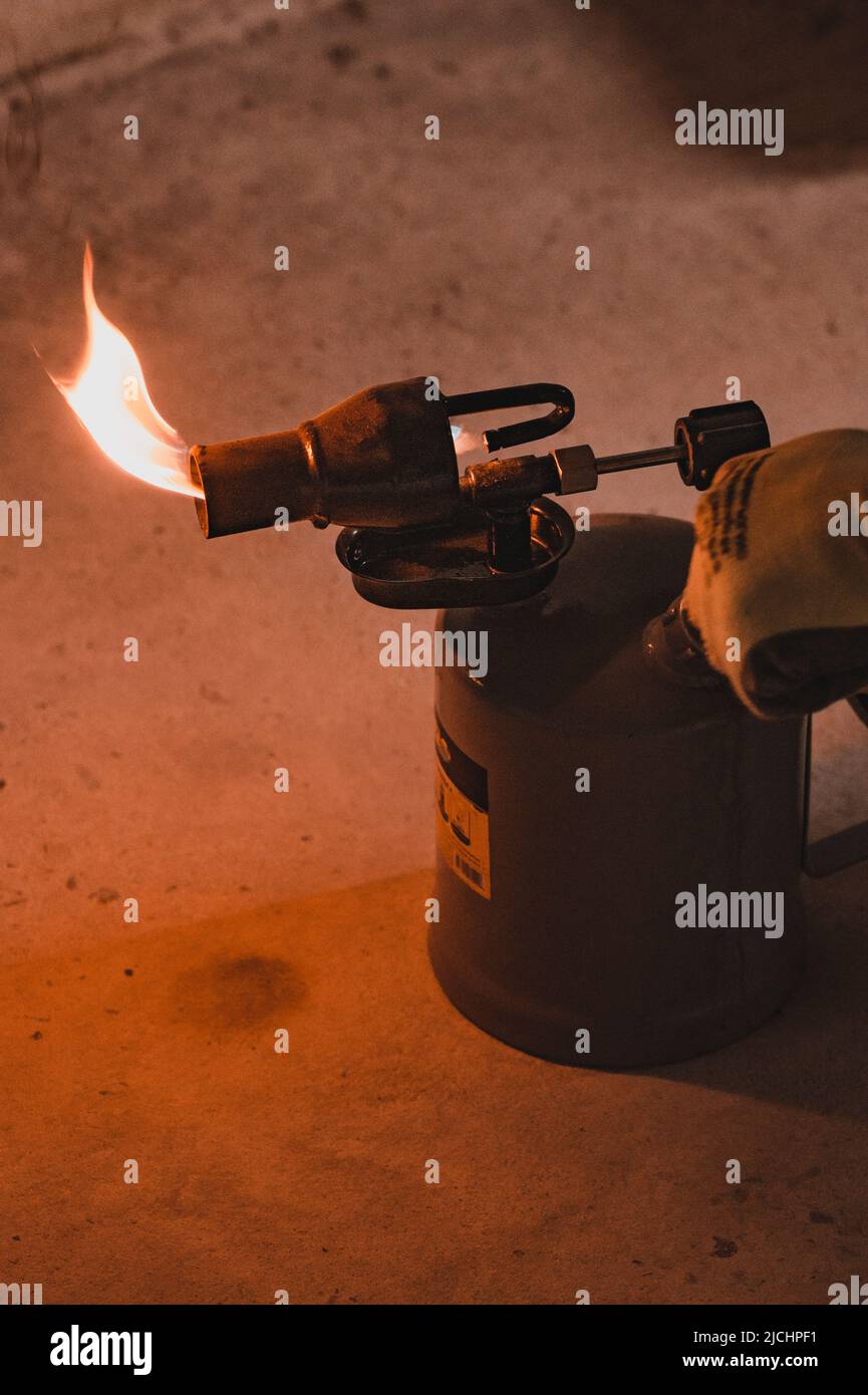 Gasoline blowtorch with a burning fire, the use of a blowtorch in