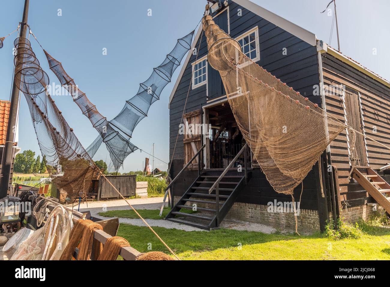 Enkhuizen, Netherlands, June 2022. Traditional fishing boats and nets hanging out to dry at the Zuiderzee Museum in Enkhuizen. High quality photo. Sel Stock Photo