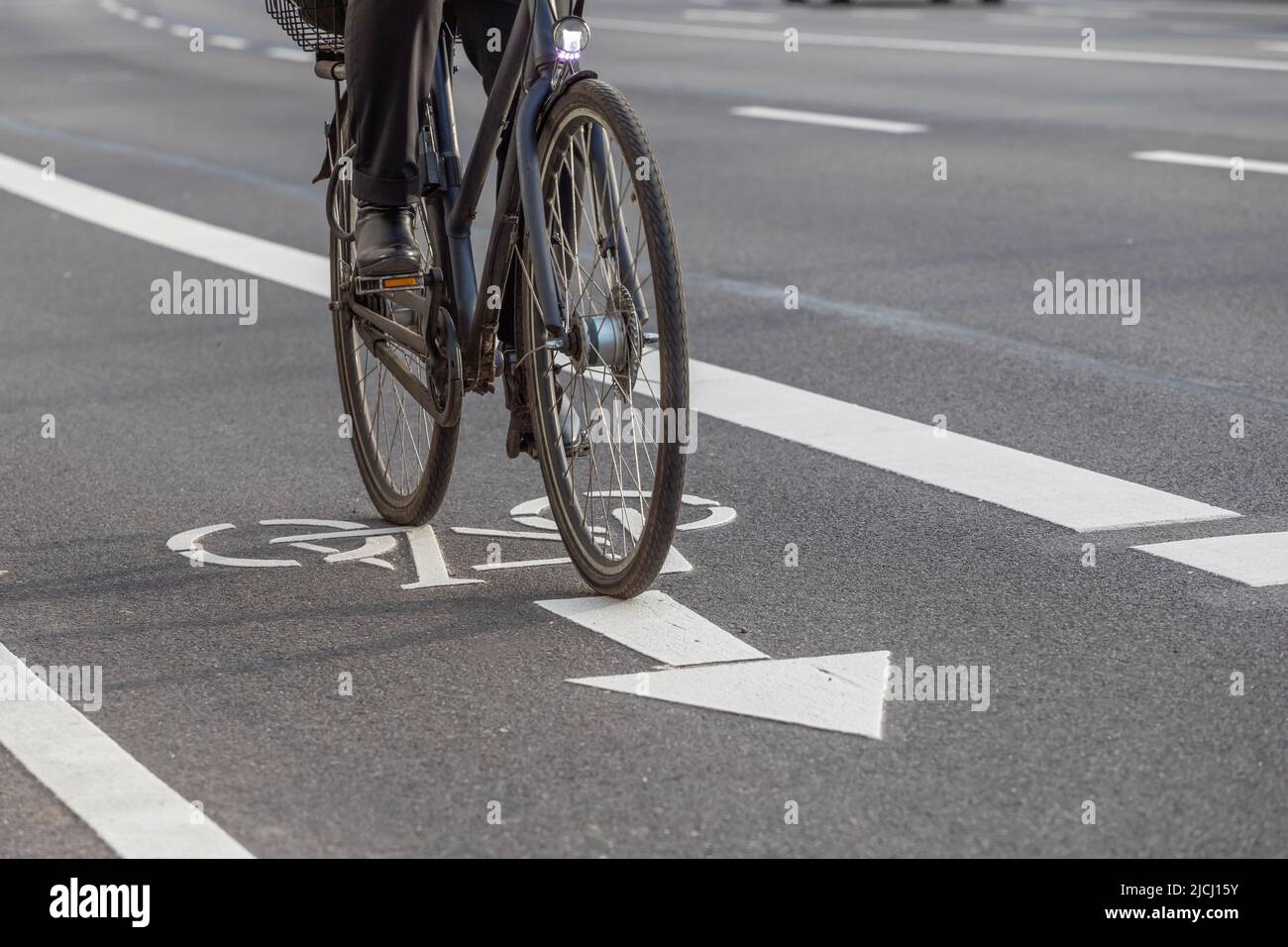 cyclist rides on bike lane via bicycle pictogram Stock Photo