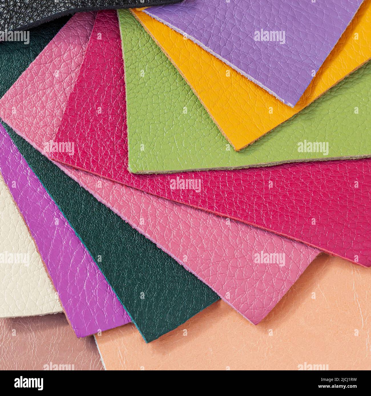 Various samples of genuine leather samples of different colors for choice. Manufacturing concept Stock Photo