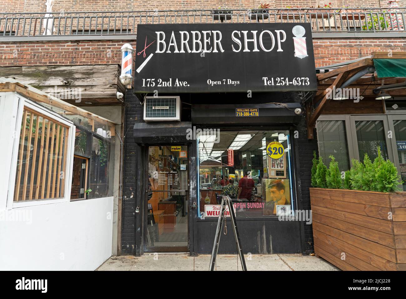 The exterior of a barber shop on Second Avenue in Manhattan's East Village (formerly known as the Lower East Side). Stock Photo