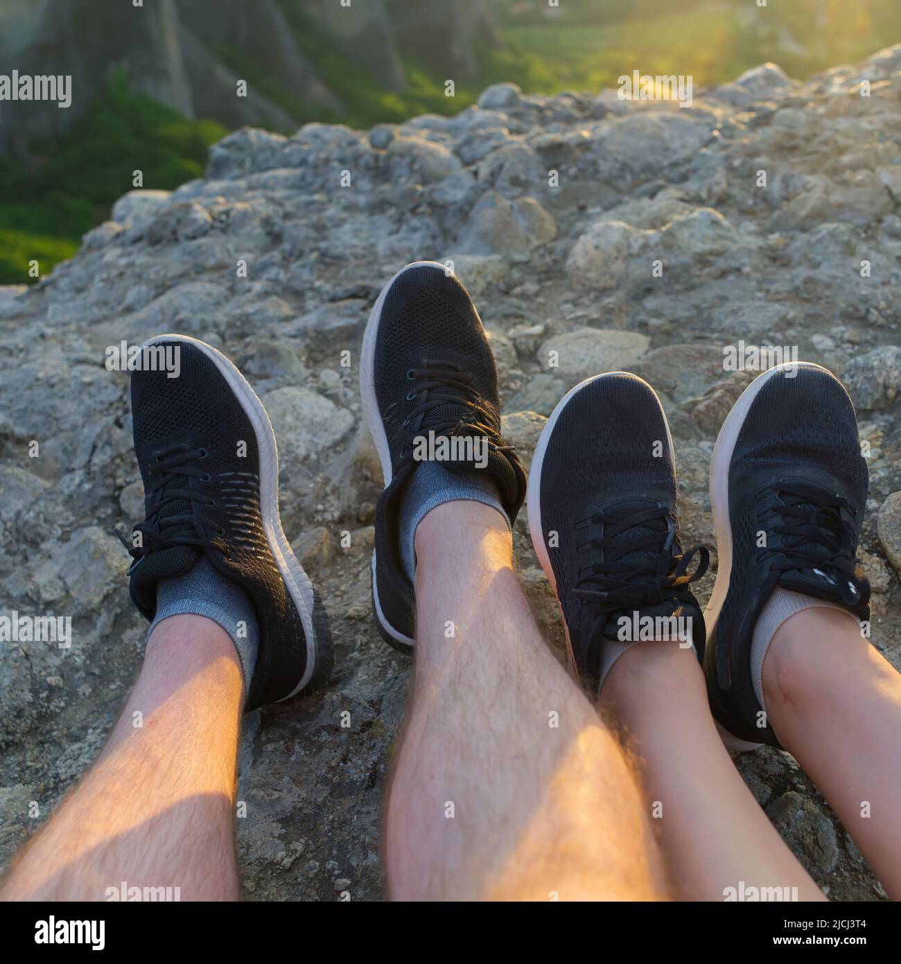 couple feet relaxing in sunny mountains, summer travel together concept. Greece, Meteora rocks Stock Photo