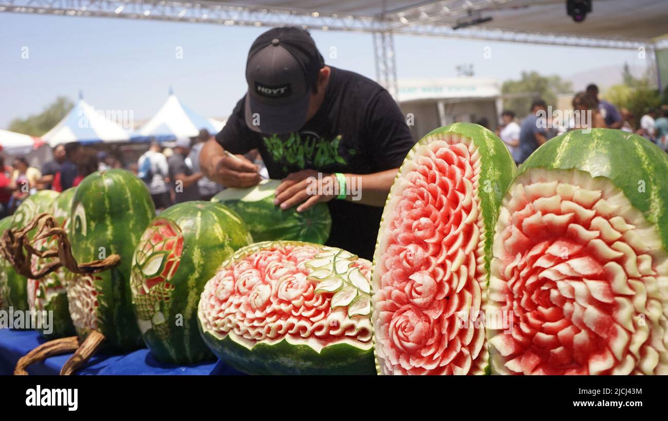 Los Angeles, USA. 12th June, 2022. An artist carves a watermelon at the