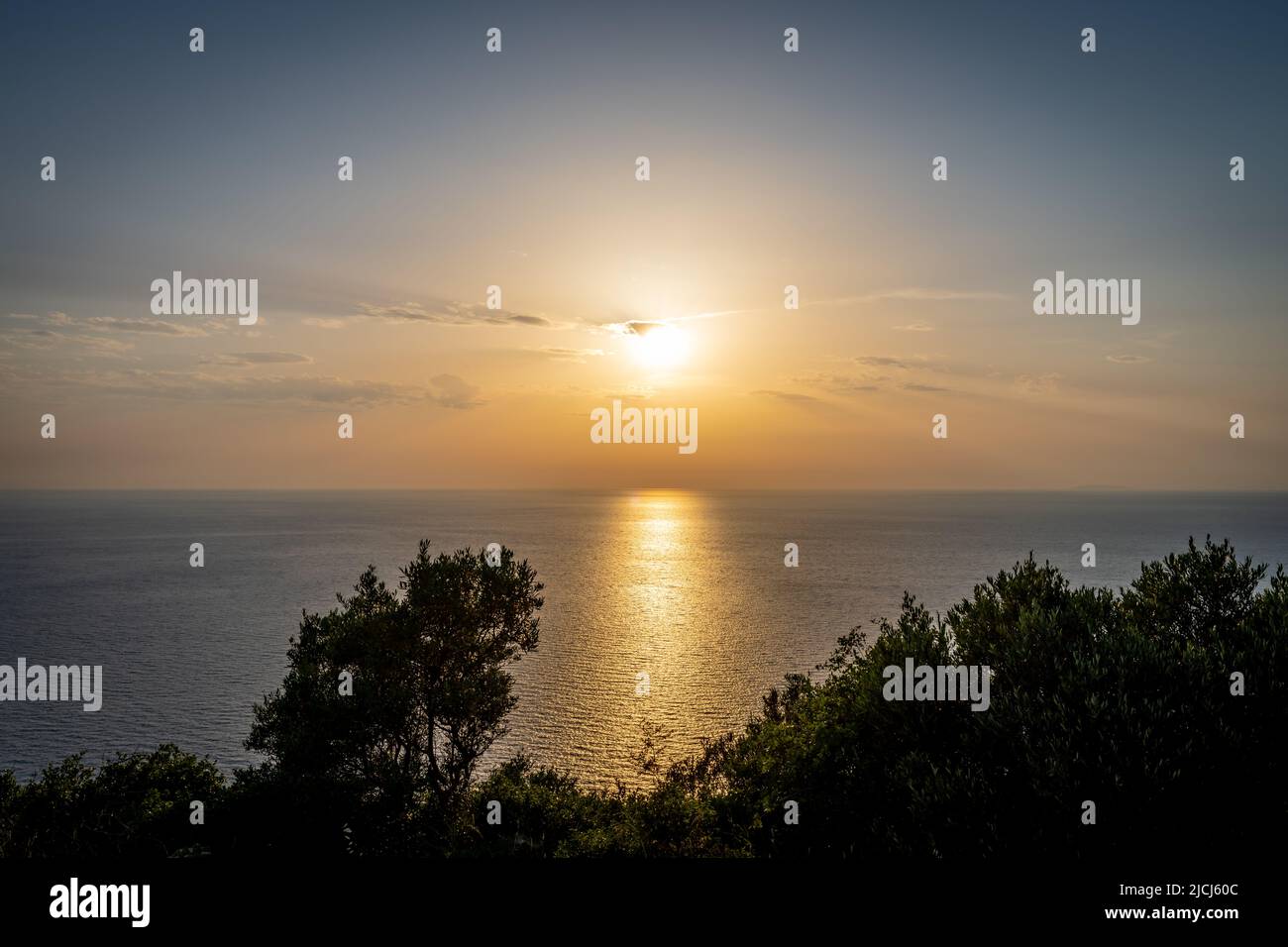A beautiful sea sunset with the sun casting light reflection on the sea. Lefkada island, Greece Stock Photo