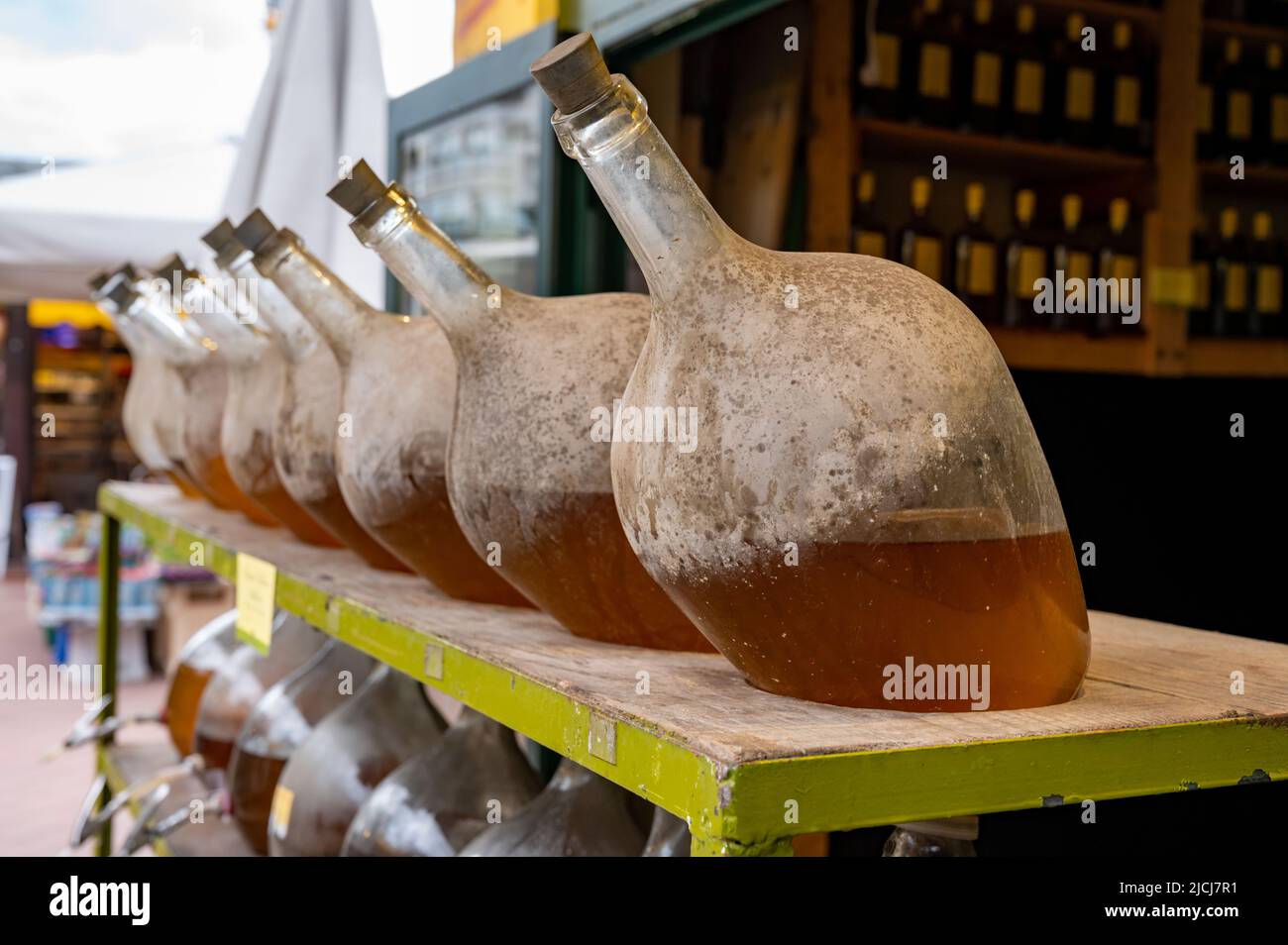 Big bottles with white wine Austrian vinegar made from local grapes on