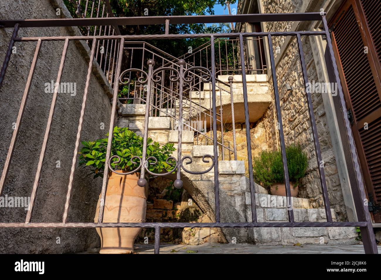 The stairs of a beautiful traditional stone house on Ithaca Island, Greece, decorated with pot plants. Stock Photo