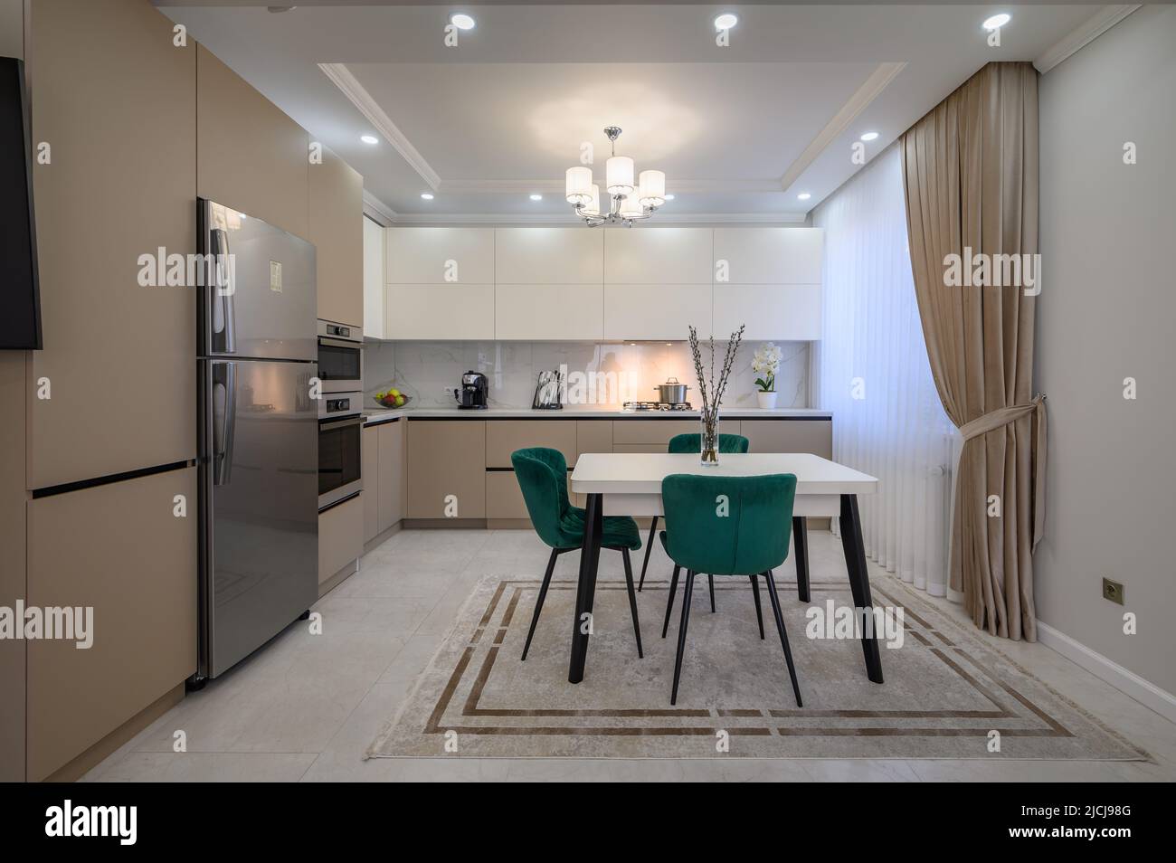 Modern white and beige large luxurious kitchen and dining table in