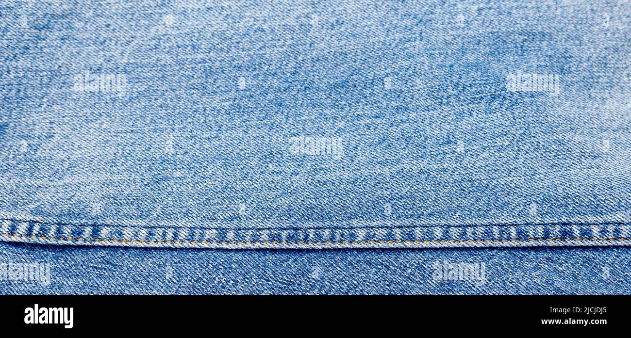 Jeans texture with horizontal seam, denim texture. Stock Photo