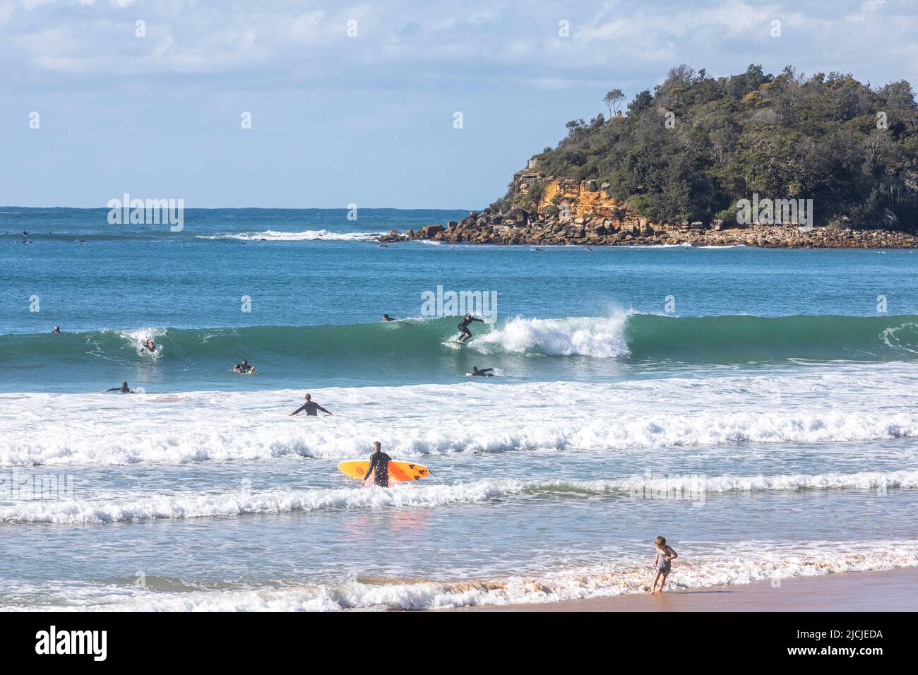 People surfing off the coast at Manly Beach in Sydney with shelly