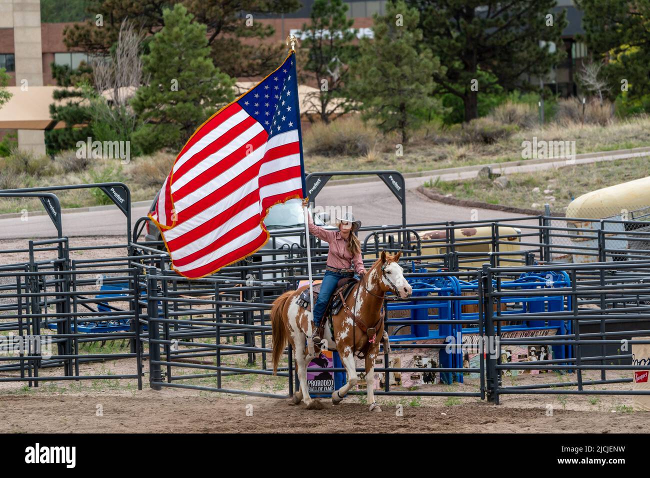Rodeo in Colorado Springs, Colorado starts with the National Anthem and the U.S. Flag Stock Photo