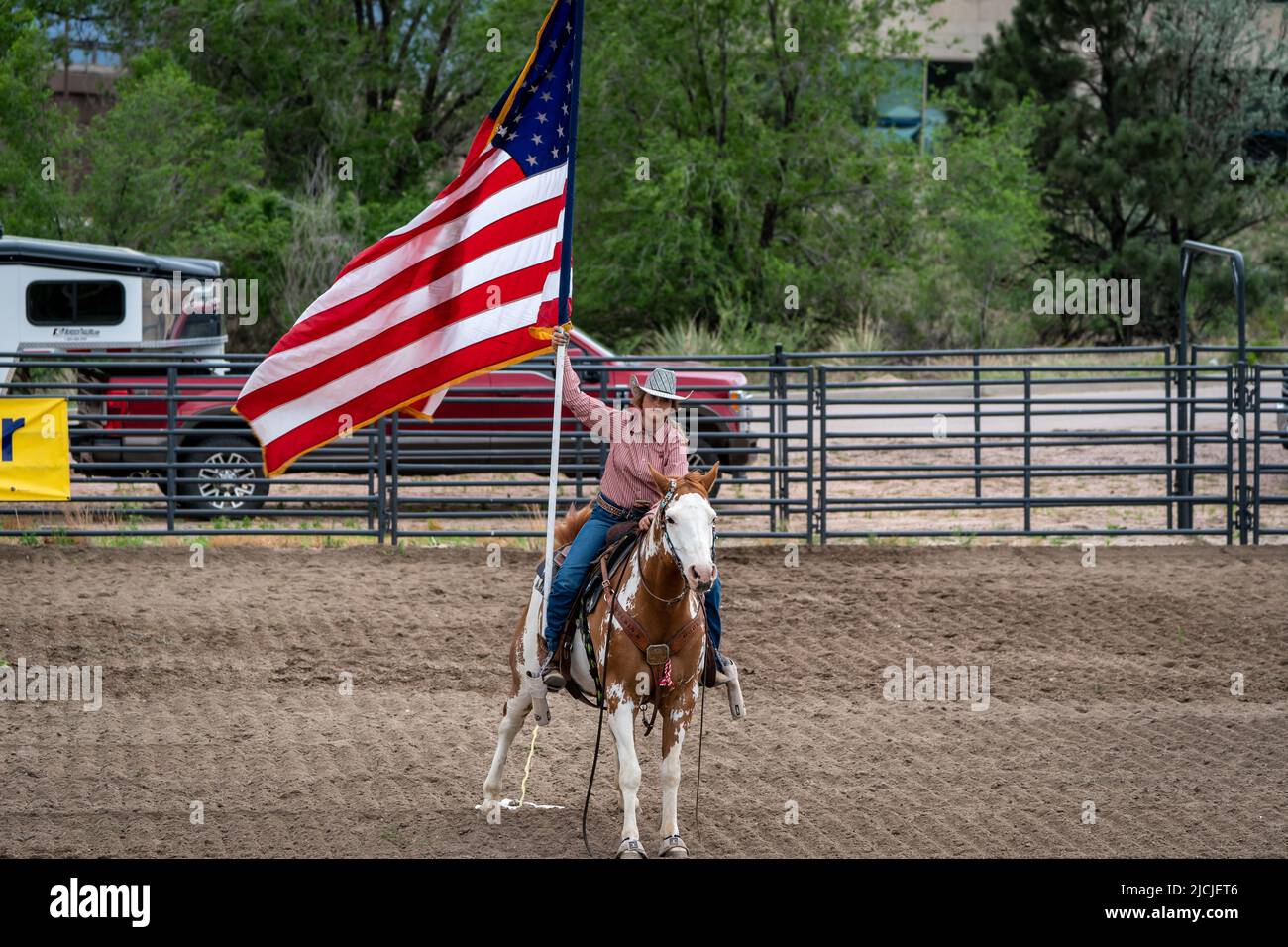 Rodeo in Colorado Springs, Colorado starts with the National Anthem and the U.S. Flag Stock Photo