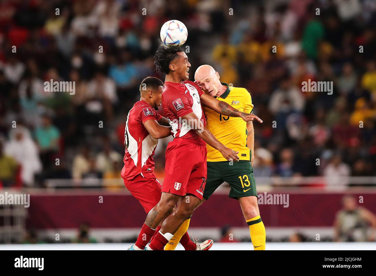 Doha, Qatar. 13th June, 2022. Aaron Mooy (R) of Australia vies with Renato Tapia (C), Christofer Gonzales of Peru during the FIFA World Cup 2022 intercontinental play-offs match between Australia and Peru at the Ahmed bin Ali Stadium, Doha, Qatar, June 13, 2022. Credit: Wang Dongzhen/Xinhua/Alamy Live News Stock Photo