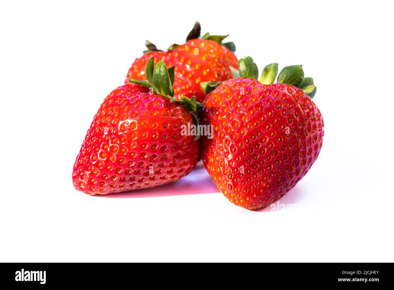 Three strawberries isolated on a white background Stock Photo