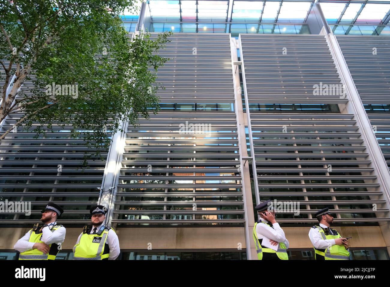 London, UK, 13th June, 2022. Police stand guard outside the Home Office as hundreds of protesters and campaigners held a rally outside the Home Office against the proposed off-shoring plans to 'process' refugees in Rwanda. The first flight is scheduled to leave on Tuesday evening after a legal challenge in the High Court to stop the flight, failed. It is expected those on the plane will be single digits in number and on arrival be encouraged to claim asylum in the east African country. Credit: Eleventh Hour Photography/Alamy Live News Stock Photo
