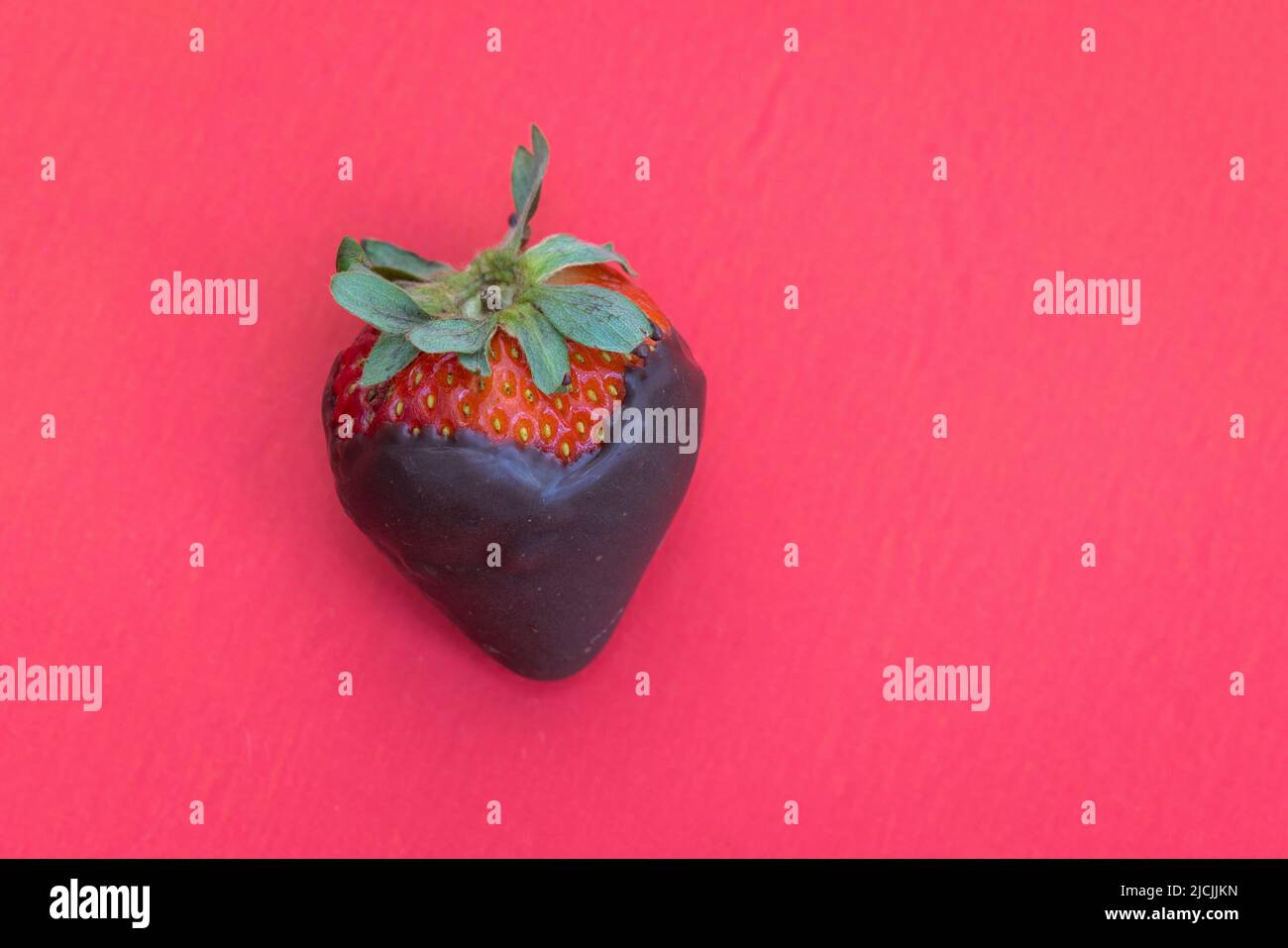 chocolate covered strawberry isolated on a red background Stock Photo