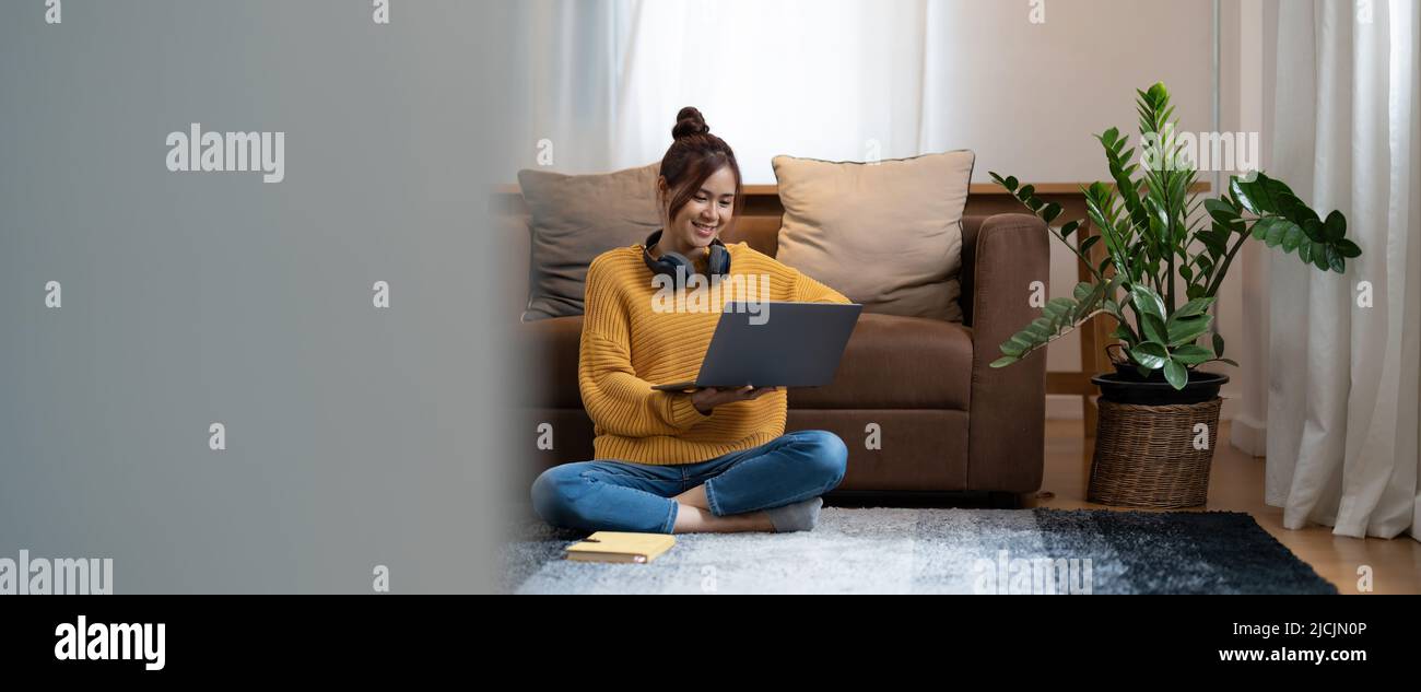 hand typing keyboard laptop online chatting search form internet while working sitting on floor.concept for work from home.technology device contact Stock Photo