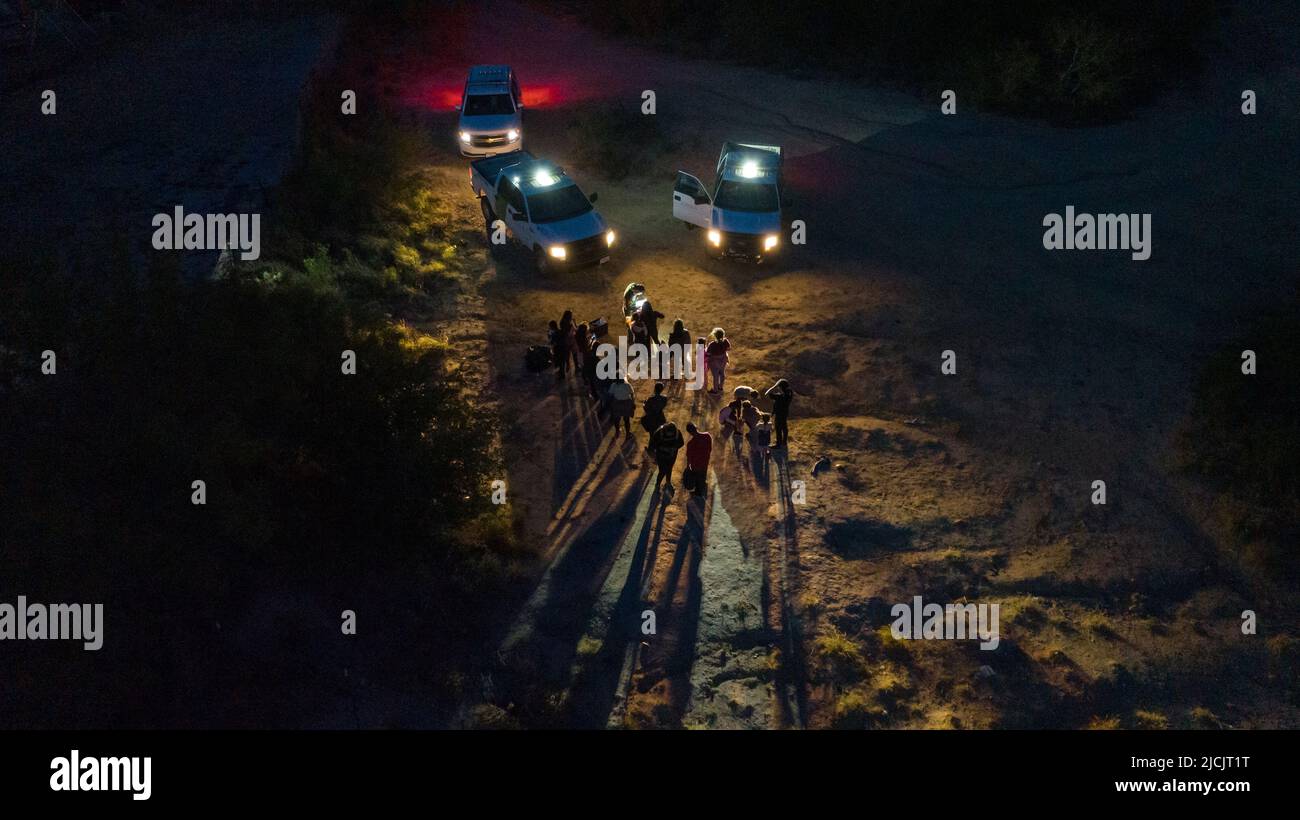 Asylum seeking migrants from Central and South America are registered by border patrol agents after they crossed the Rio Grande river into the United States from Mexico in Roma, Texas, U.S., June 13, 2022.  Picture taken June 13, 2022. Picture taken with a drone.  REUTERS/Adrees Latif     TPX IMAGES OF THE DAY Stock Photo