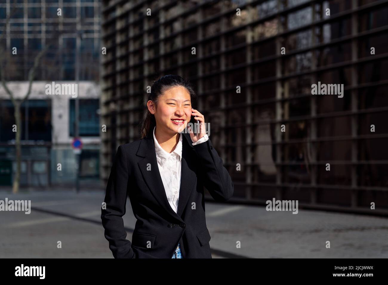 young businesswoman walking talking by phone Stock Photo