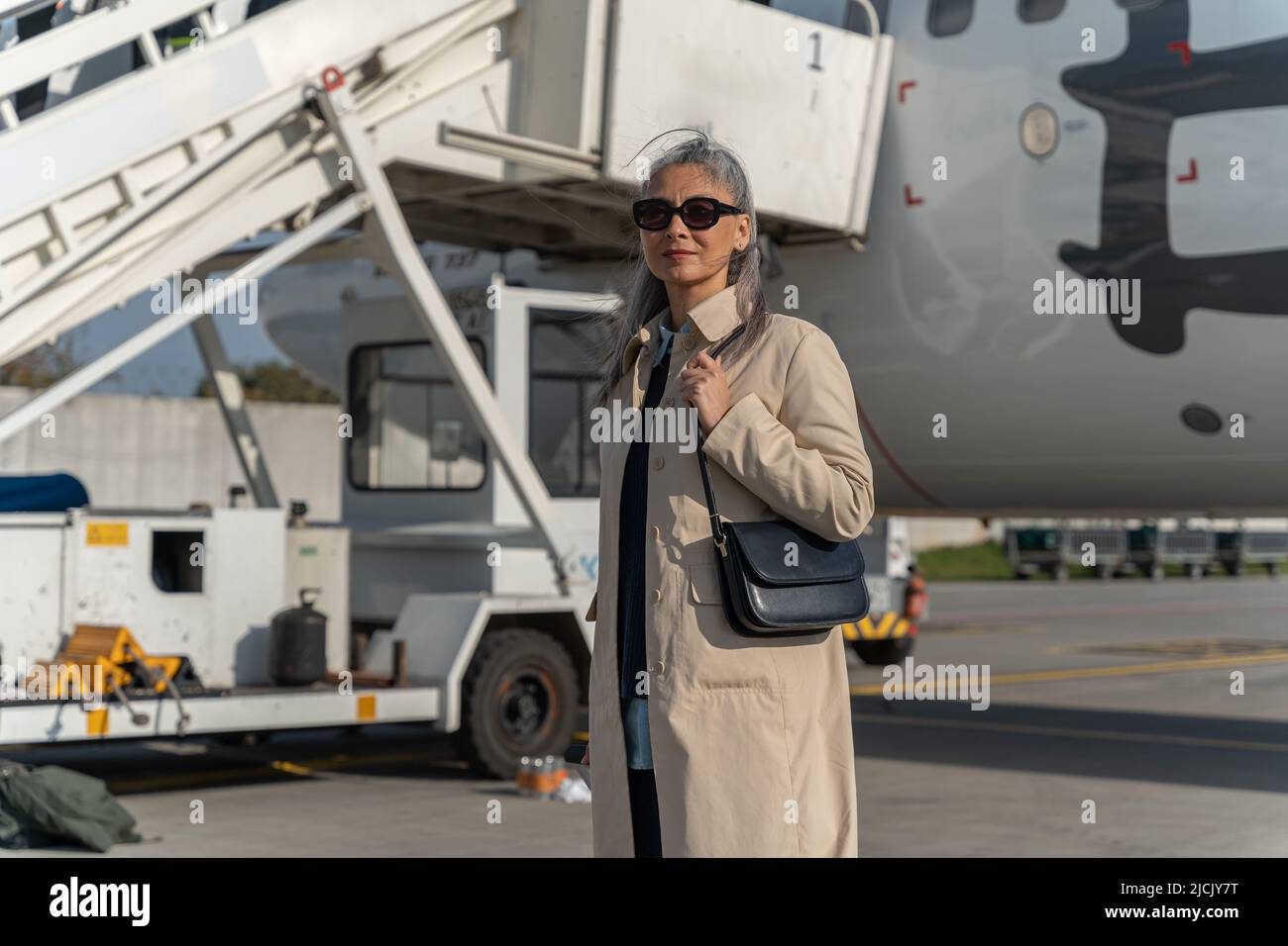 Woman in sunglasses plane hi-res stock photography and images - Alamy