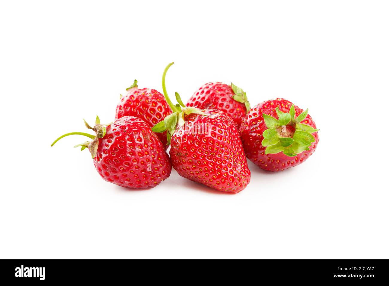 Fruits of ripe red strawberries with green leaves on a white background ...