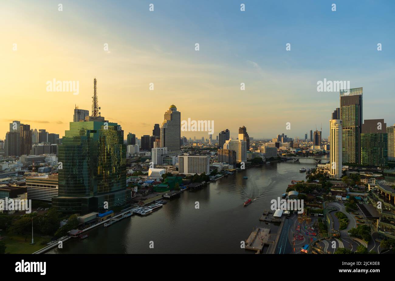 Chao Phraya River with King Taksin bridge and building of Bangkok city with sunlight in the morning, Thailand Stock Photo