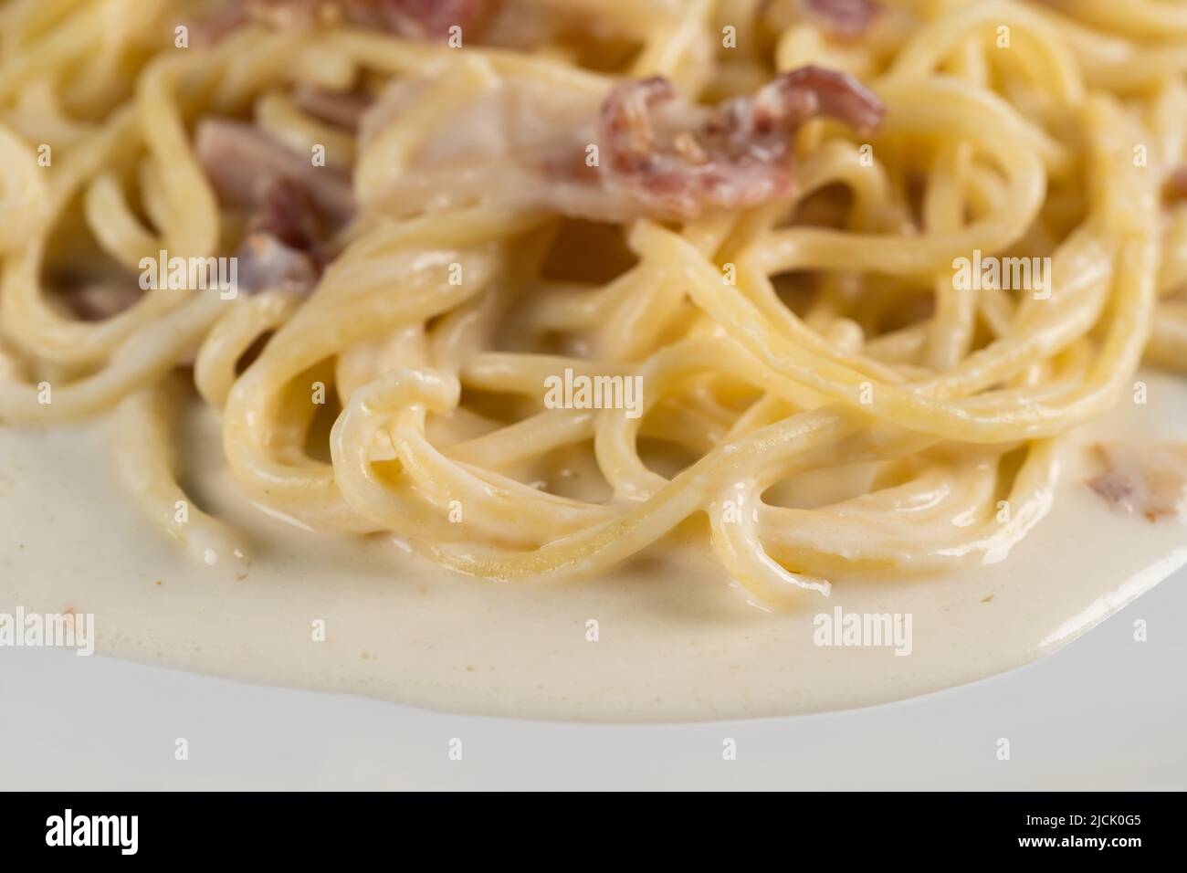 close up carbonara spaghetti with cream on a white plate Stock Photo