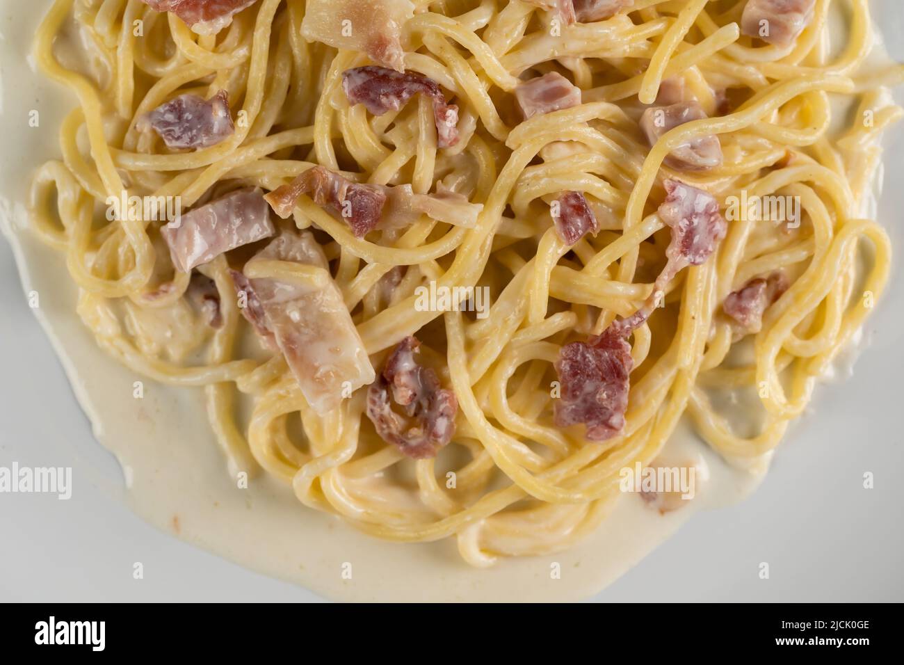 carbonara spaghetti with cream on a white plate Stock Photo
