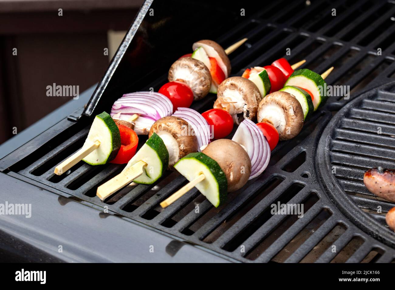 Grilling marinated shashlik on a grill. Shashlik is a form of Shish kebab  popular in Eastern, Central Europe and other places. Shashlyk meaning skewer  Stock Photo - Alamy