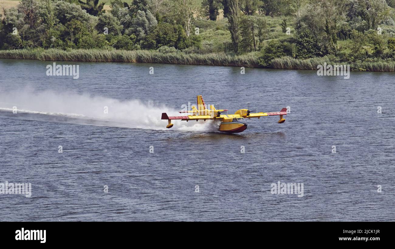 bombardier 415 amphibious aircraft, during the water loading phase in a lake Stock Photo