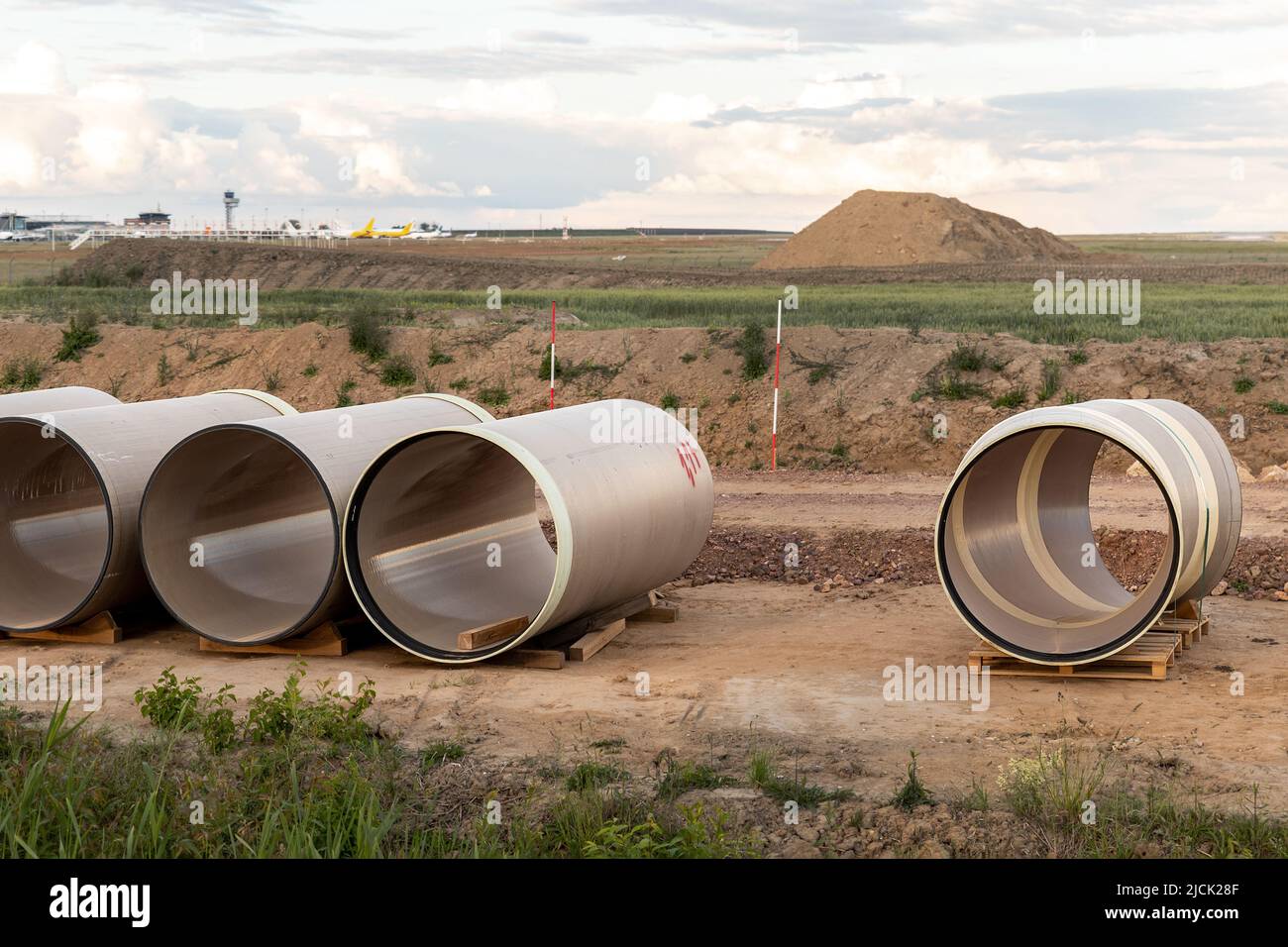 Stack of big frp composite fiberglass plastic sewage pipes at warehouse