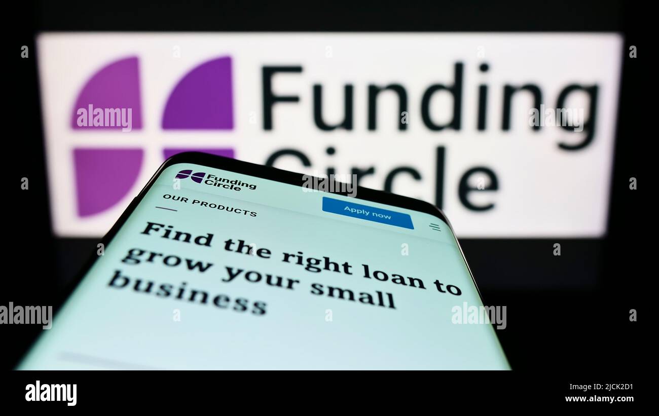 Mobile phone with website of British lending company Funding Circle Ltd. on screen in front of business logo. Focus on top-left of phone display. Stock Photo