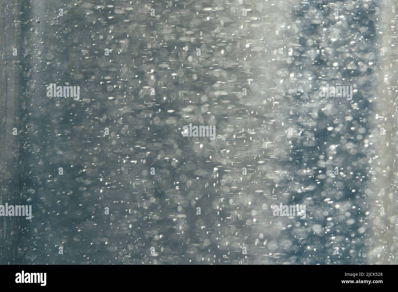 Bubbles in liquid gel on grey background. Authentic makeup texture Stock Photo