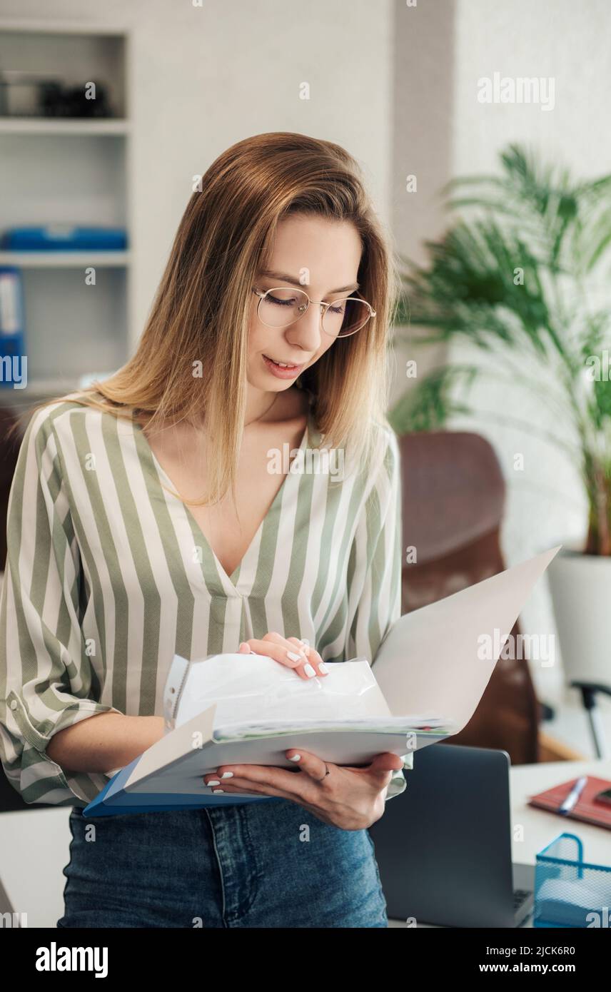 Young woman working on a computer in her office Stock Photo - Alamy
