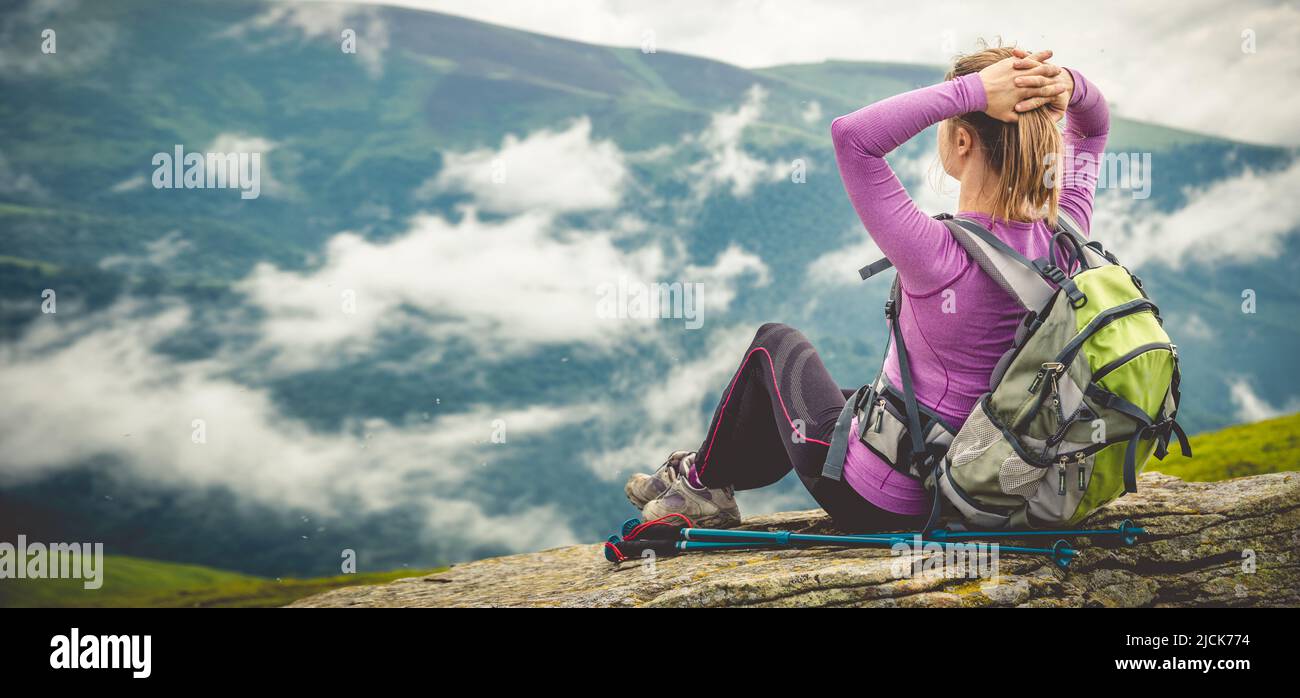 Young woman hiking in the mountains Stock Photo - Alamy