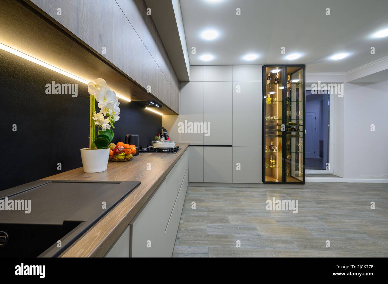 Trendy grey modern kitchen interior with minimalistic furniture Stock