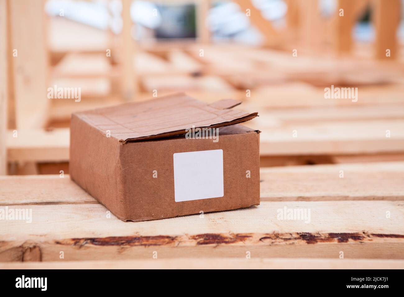 Cardboard box with construction nails or self-tapping screws, blank marking sticker for text Stock Photo