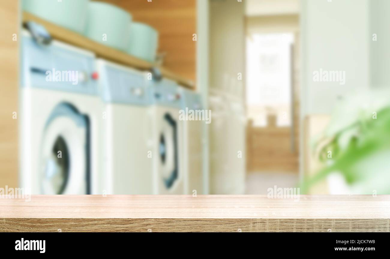 Laundry room table background. Blurred home laundry room with wooden