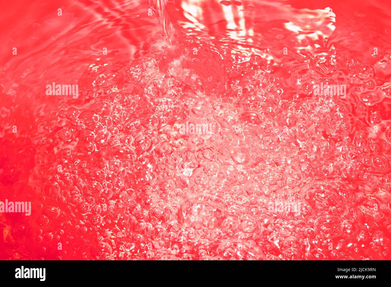 Red abstract chaotic backgroud with seamless pattern. Red liquid surface texture. Stock Photo