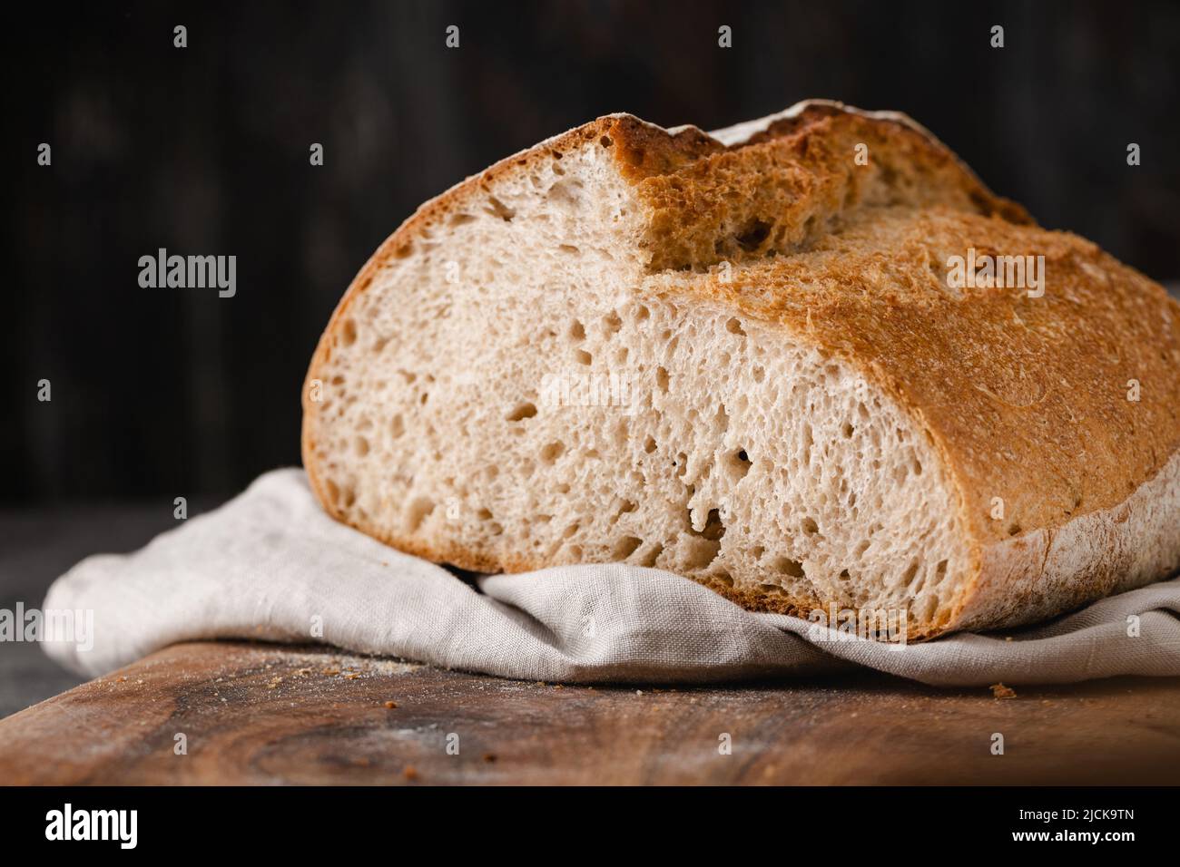 Sourdough loaf of bread on cutting board. Stock Photo